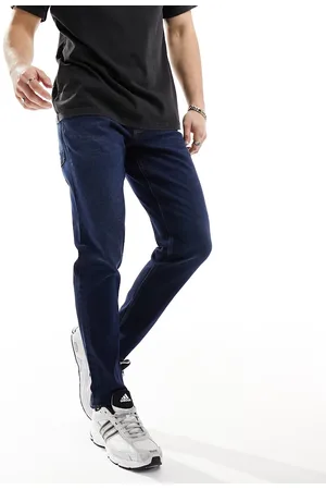 ASOS Vaqueros tapered azules con lavado oscuro de corte elástico de