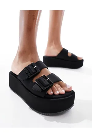 ASOS Sandalias negras estilo mules con plataforma plana y tiras con hebillas Taxon de