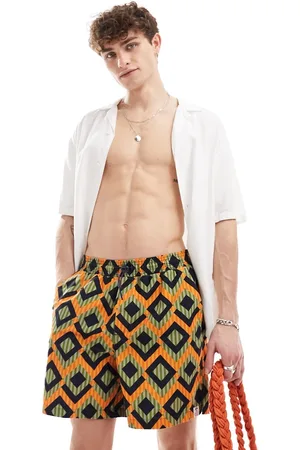 Hunky Trunks Shorts de baño verdes y naranjas con estampado geométrico a rayas de