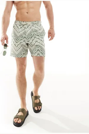 ASOS Shorts de baño cortos verdes con estampado geométrico de