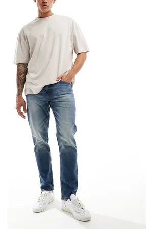 ASOS Vaqueros de corte tapered elástico con lavado azul medio vintage de