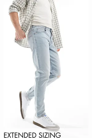 ASOS Vaqueros azules rasgados de corte tapered con lavado claro de