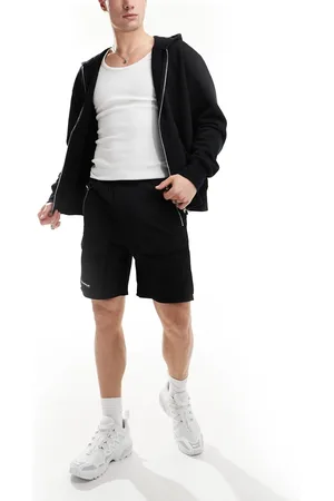 The Couture Club Pantalones cortos cargo negros con diseño de paneles en contraste de