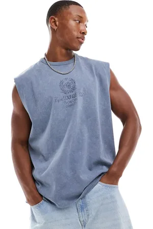 ASOS Camiseta azul lavado extragrande sin mangas con estampado deportivo en el pecho de tejido grueso de 220 g/m2 de