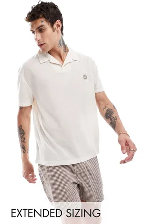 ASOS Polo holgado con estampado celestial en el pecho de tejido texturizado de - neutro