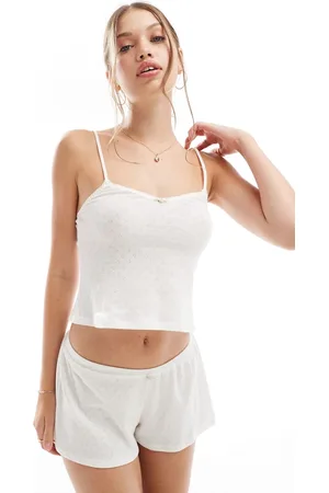Dorina Camisola marfil de punto pointelle con detalle de flor rosa de