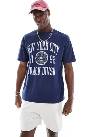 Cotton On Camiseta azul añil de corte suelto con estampado universitario "NY Track" de Cotton On