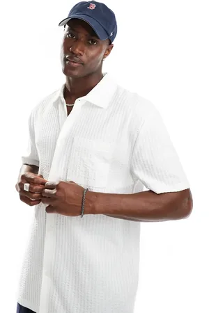 ASOS Polo holgado con bolsillo delantero de