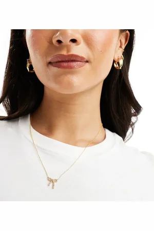 Accessorize Collar chapado en oro con colgante en forma de lazo con cristales de la colección Z de