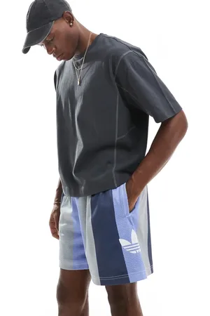adidas Pantalones cortos azules a rayas de estilo baloncesto de