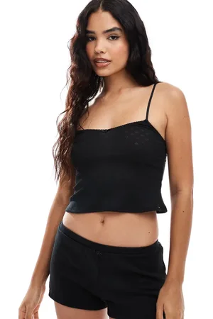 Dorina Camisola negra de pointelle con detalle de rosa de