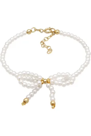 Elli Pulsera blanca con diseño romántico y detalle de lazo de cuentas de vidrio y plata de ley 925 chapada en oro de