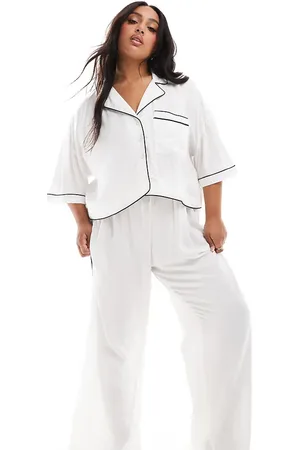 ASOS Pantalones de pijama blancos elegantes de pernera ancha con ribetes en contraste de tejido muy suave de ASOS DESIGN Curve