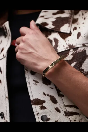 ARKET Pulsera rígida con detalle de lazo chapada en oro de