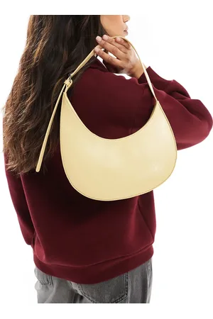 ASOS Bolso de hombro amarillo crema con diseño redondeado asimétrico y detalle de hebilla de