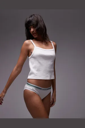 Lacoste Braguitas blancas con banda con logo en el centro de