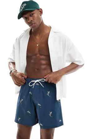 Hollister Boardshorts de 8" azules con estampado de peces y raya en contraste de