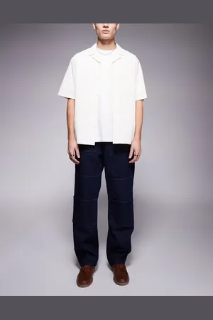 ASOS Vaqueros azules holgados de estilo carpintero con lavado claro y detalle de bolsillo delantero de