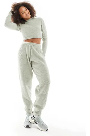 Nike Joggers de talle alto con estampado integral del logo de bouclé Phoenix de