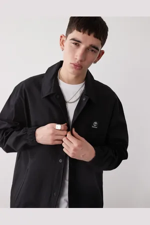 Timberland Chaqueta negra de estilo entrenador con logo en el pecho de tejido antidesgarros de