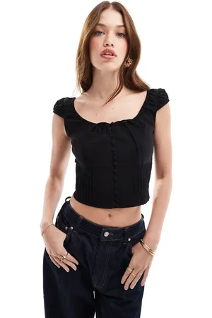 MANGO Blusa negra con lazada delantera y mangas abullonadas de