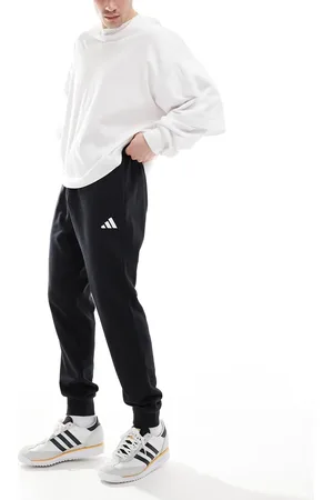 adidas Pantalones negros y blancos de felpa rizada Feel Cozy de adidas Essentials