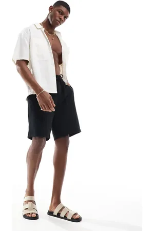 JJ Pantalones cortos negros de corte suelto de punto liso de
