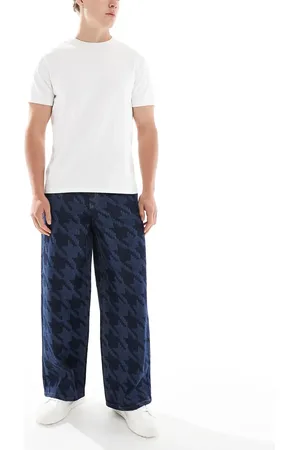 ASOS Vaqueros muy holgados con lavado crudo y estampado de pata de gallo a láser de -Azul