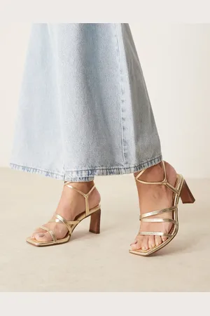 ASOS Sandalias doradas con tacón medio grueso y diseño de tiras anudadas a la pierna Hideaway de