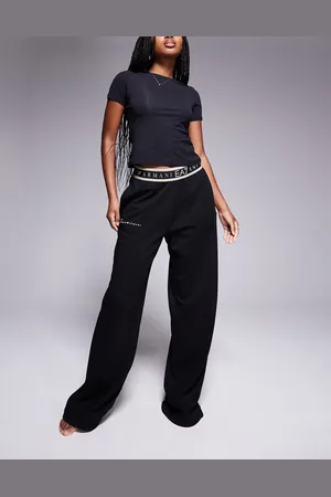 EA7 Pantalones negros de pernera ancha con logo en la cinturilla de Armani
