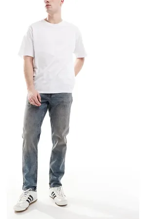 River Island Vaqueros azules de corte tapered con lavado medio de