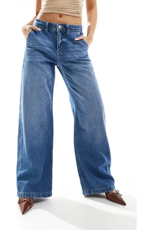 River Island Vaqueros azules holgados con lavado medio de