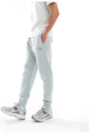 Nike Joggers azul claro con estampado gráfico del logo Swoosh de Club-Gris
