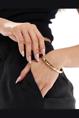 Accessorize Pulsera rígida dorada con diseño celestial y gemas de