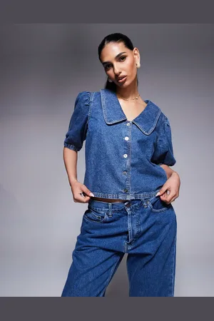 River Island Top vaquero con lavado azul medio y mangas abullonadas de