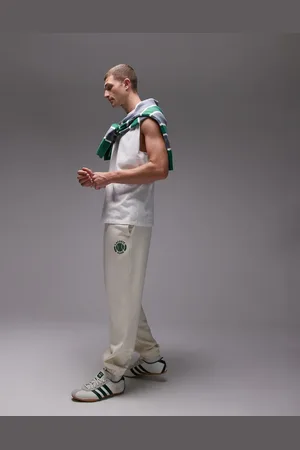 Lacoste Joggers blancos con emblema de tenis de