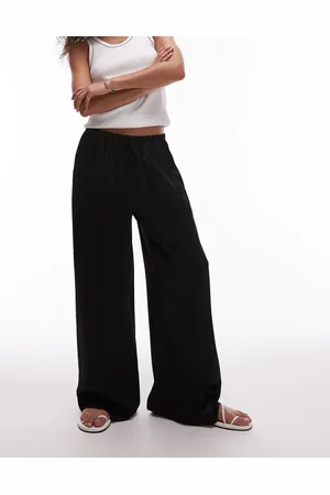 Topshop Pantalones negros de pernera ancha con lazada en la cintura de satén de