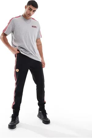 adidas Pantalones de chándal negros y rojos con diseño del Manchester United Icons de adidas Football