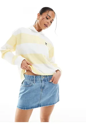 Hollister Minifalda vaquera de talle bajo con bajo deshilachado y lavado azul medio de