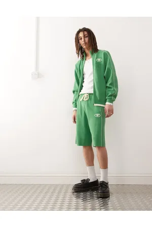 A Bathing Ape Pantalones cortos verdes de corte suelto con franja lateral de punto grueso de
