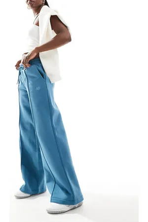 New Balance Pantalones azules de pernera ancha de felpa de