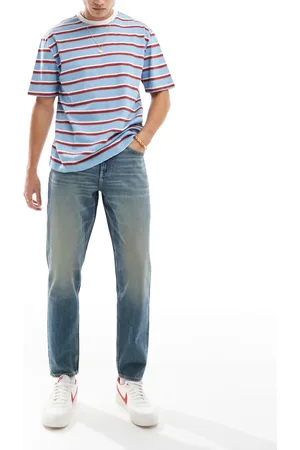 ASOS Vaqueros de corte tapered con lavado azul medio y tintado vintage de
