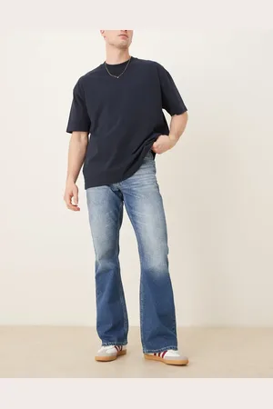 ASOS Vaqueros de campana con acabado vintage y lavado azul medio de