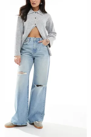 Calvin Klein Vaqueros azul claro tintado de pernera ancha con diseño rasgado de