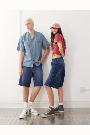 Reclaimed Pantalones cortos vaqueros azul lavado unisex de corte skater de