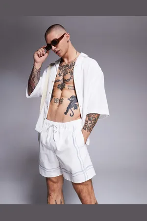 ASOS Shorts de baño color de largo medio con borde estampado de -Neutro