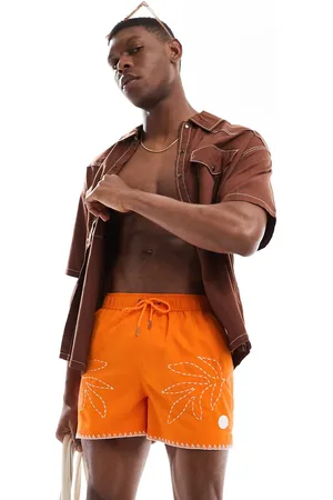 Native Youth Shorts de baño naranjas con diseño bordado de