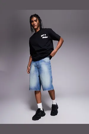ASOS Pantalones cortos vaqueros de corte alargado y estilo carpintero con lavado azul medio de