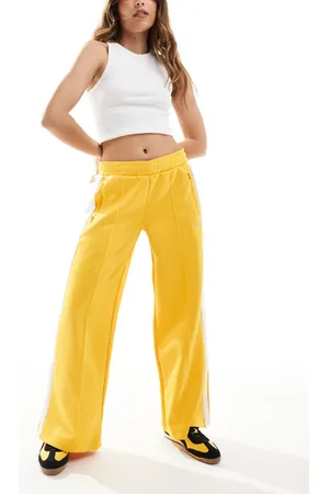 PUMA Pantalones de chándal amarillos de talle bajo T7 de