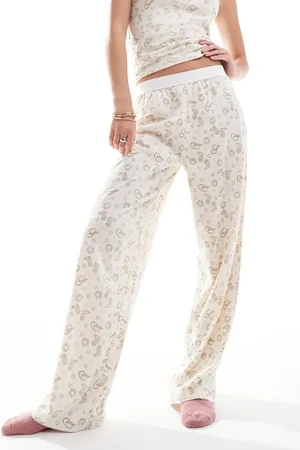 ASOS Pantalones de pijama con estampado de rodeo y cinturilla a la vista Mix & Match de -Beis neutro